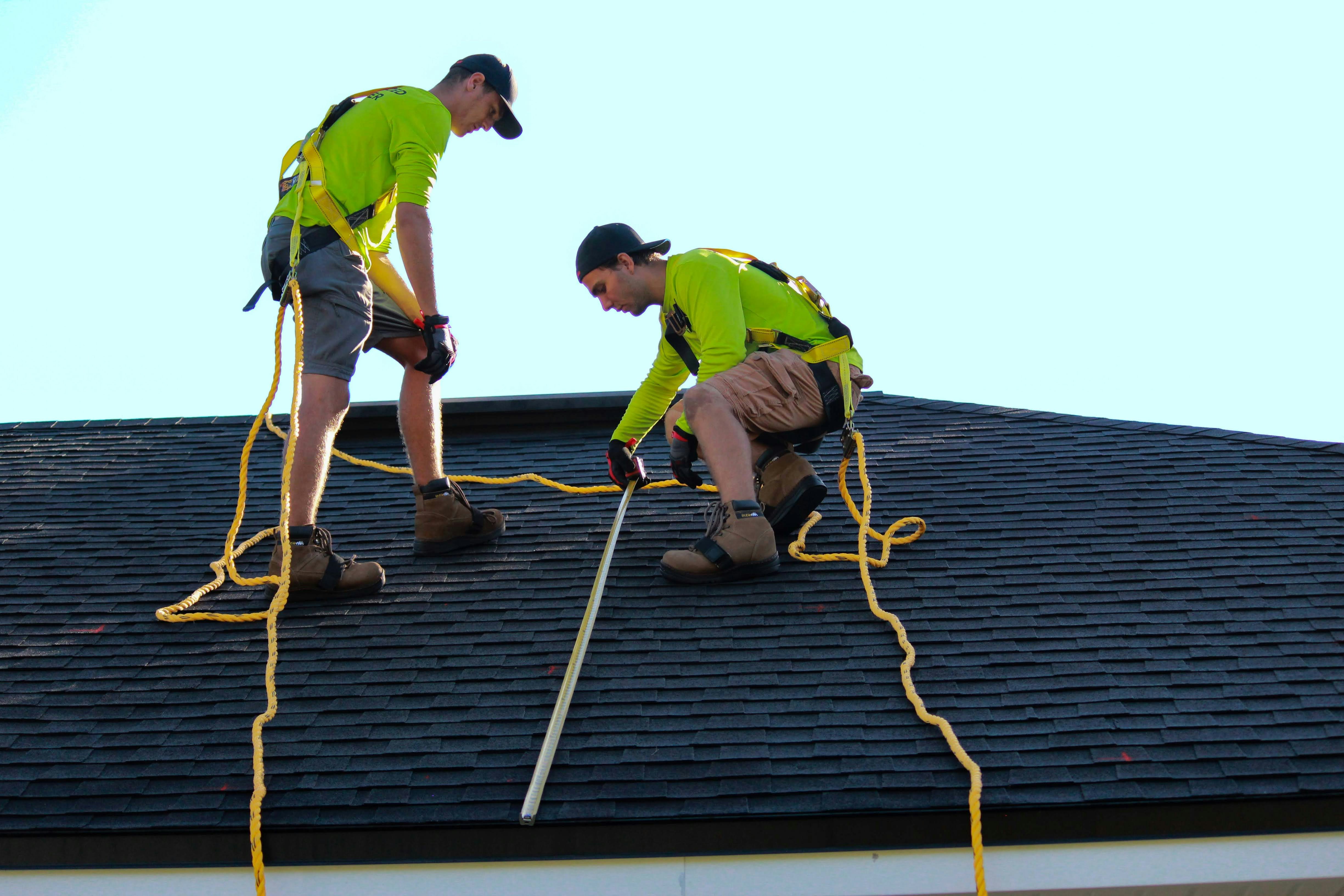 Professional roofing contractors with safety equipment